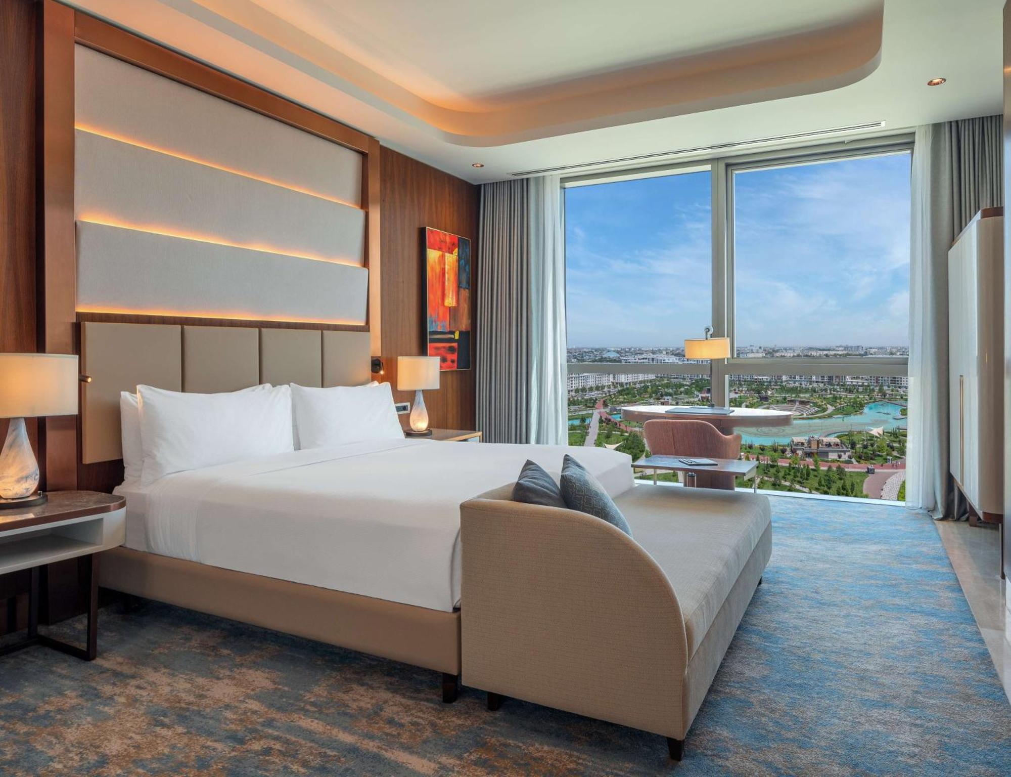 Hilton Tashkent City Екстериор снимка A bedroom at the Hilton Ras Al Khaimah